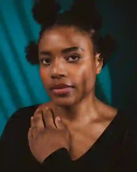 Second input photo: a young woman with four hair buns, front-facing